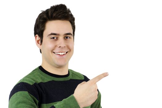 Handsome young man or student smiling and pointing at the blank or copy space beside him, perfect for advertisement or publicity.