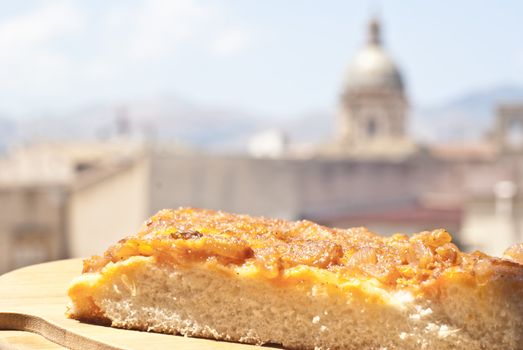 sicilian traditional pizza sfincione over backgroun of palermo.