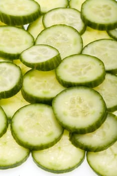 Freshly sliced cucumber  isolated on white background 