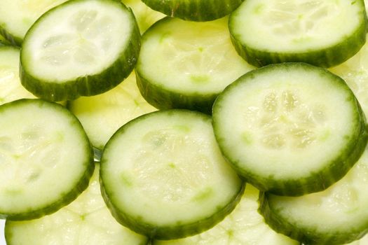 Freshly sliced cucumber  isolated on white background 