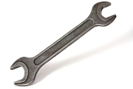 Big rusty spanner on a white background