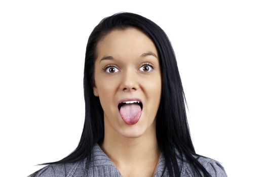 Funny and humorous portrait of a beautiful young woman making face by sticking her tongue out 