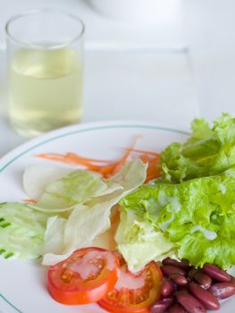 Vegetable Salad in White plate and panels with drink