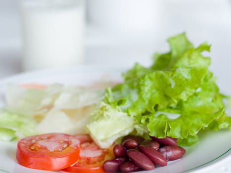 Vegetable Salad in White plate and panels with drink