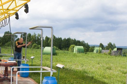 A man shoots a gun on skeet