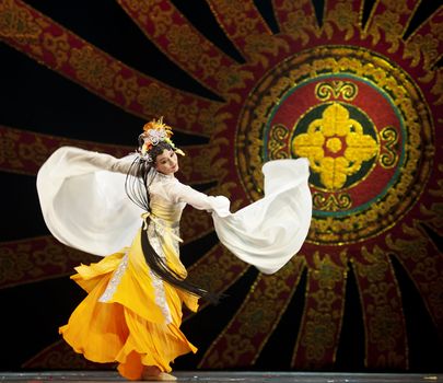 CHENGDU - OCT 17: Chinese national dancers perform folk dance on stage at JINCHENG theater on Oct 17, 2011 in Chengdu, China.