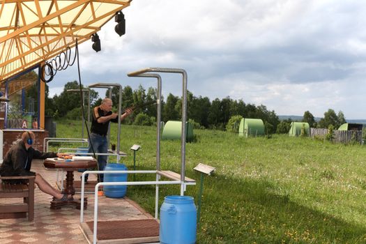 A man shoots a gun on skeet