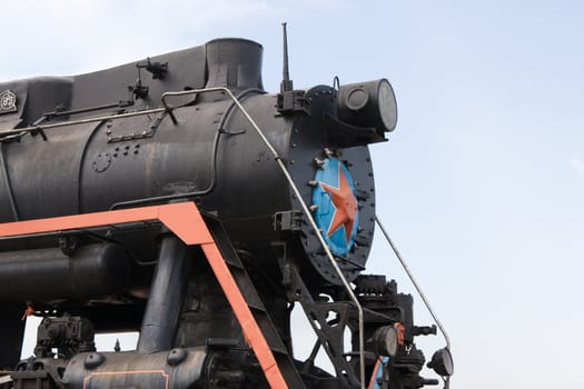 Old restored steam locomotive on a pedestal