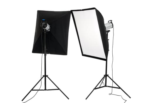 Two studio flashes on supports on a white background