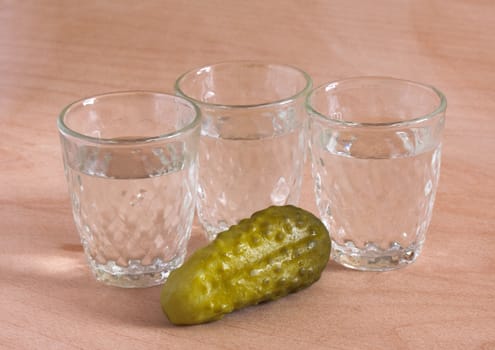 Cucumber and glasses of vodka