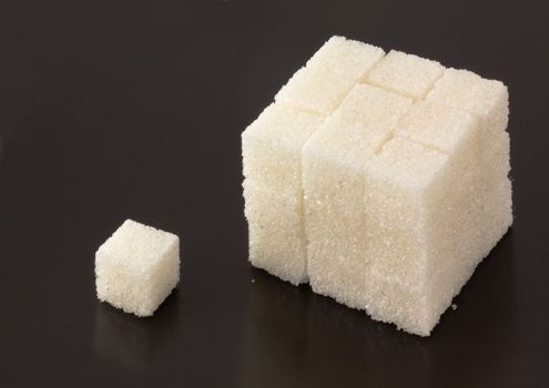 Cubes of sugar on black bacground