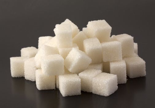 Cubes of sugar on black bacground