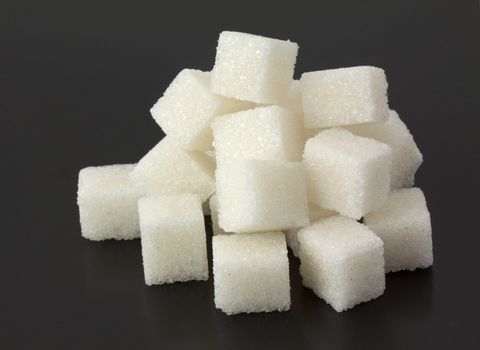 Cubes of sugar on black bacground