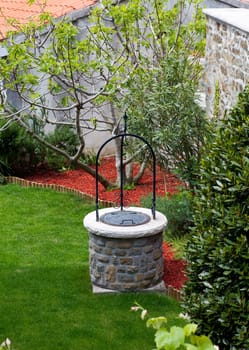 Well in the back of a house with garden