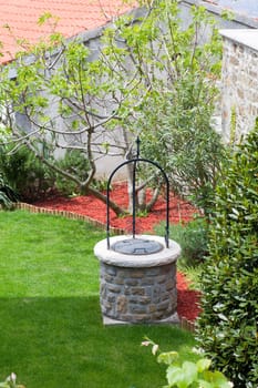 Well in the back of a house with garden