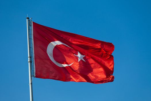 Waving flag of Turkey under blue sky 