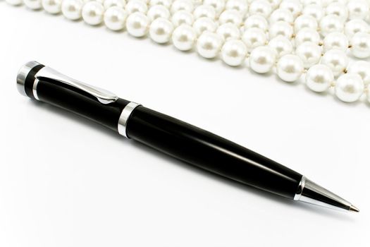 Pen with pearls in a background