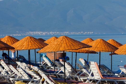 Beach loungers and umbrellas on the sea.