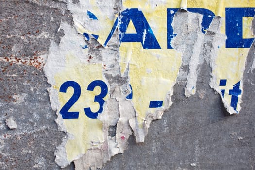 Torn posters on a iron surface