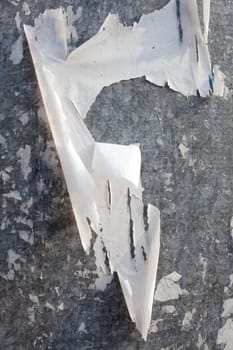 Torn posters on a iron surface