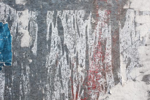 Torn posters on a iron surface