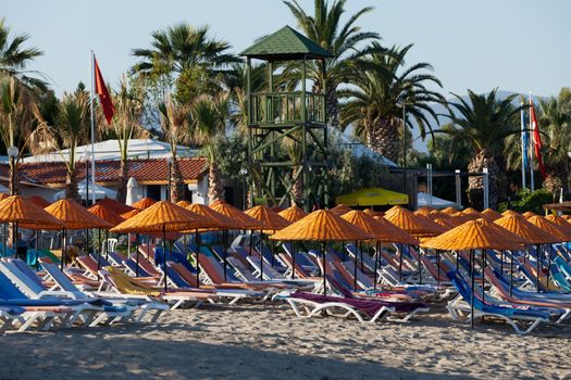 Beach loungers and umbrellas on the sea.