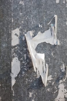 Torn posters on a iron surface