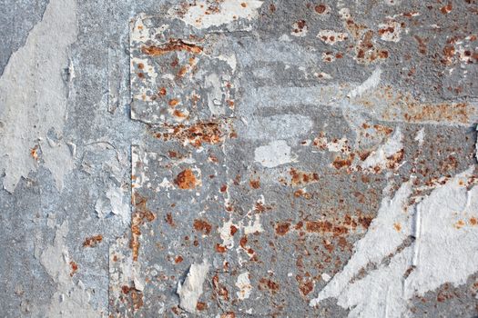 Torn posters on a iron surface