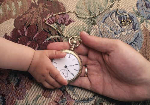 Father giving child antique pocket watch