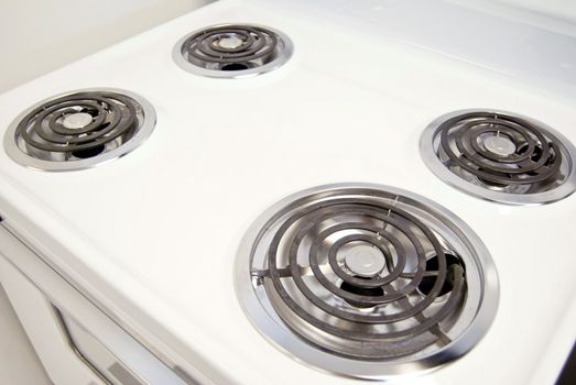 A white electric stove with four burners.