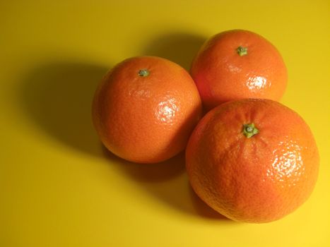 three entire citrus fruits