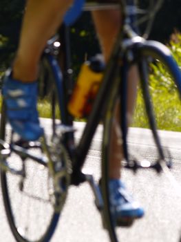 bicyclist on rural road, focus on middle of the road