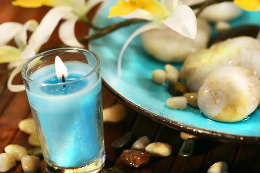 Blue aromatherpy candle and spa stones