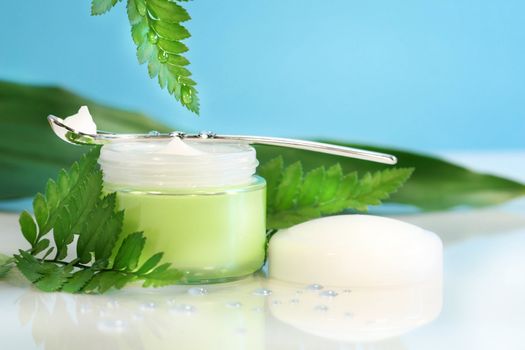 Rejuvenating face cream with ferns and droplets of water