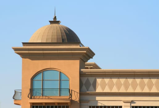 Close up of a dome over blue sky.
