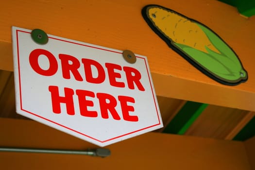 Close up of an order here sign.
