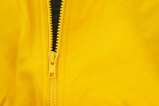 a macro picture of a yellow zipper