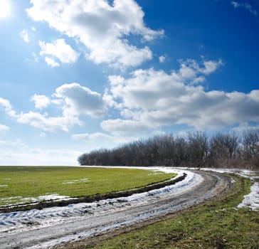 spring road under cloudy sky