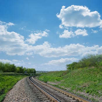 railway goes to horizon in green landscape