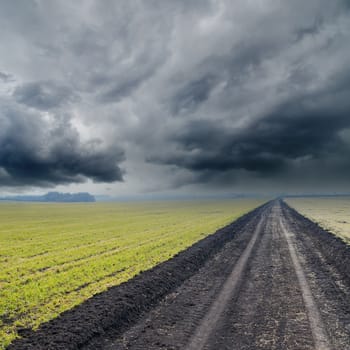 dirty road under dramatic sky. rain before