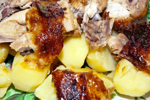 Tasty fried dish of chicken and potatoes, closeup.