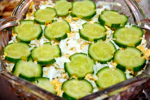 Vegetable fresh salad greens adorned with sliced ​​cucumbers