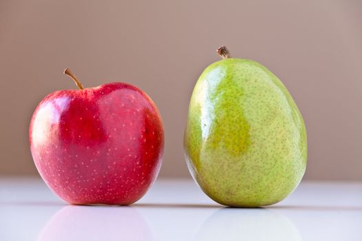 Two pieces of fruits on white with taupe brown background. Concepts: nutrition, good food choices, balanced diet, good for you