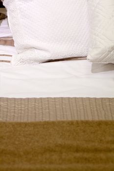 Embroidered pillows on a bed