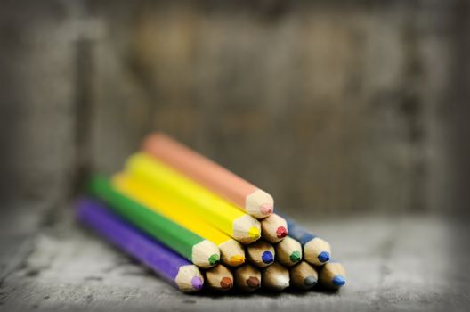 color pencils on wooden background