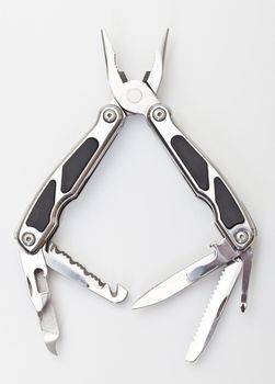 Steel pliers folding multi tool opened on white background