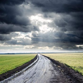dirty road to cloudy horizon. rain before