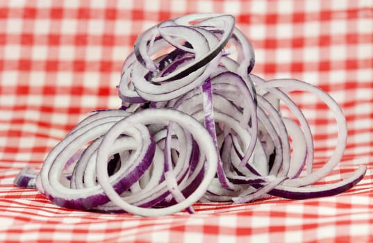 sliced oinons  of checkered tablecloth