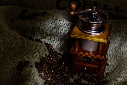 Coffee Mill with beans and burlap. still life