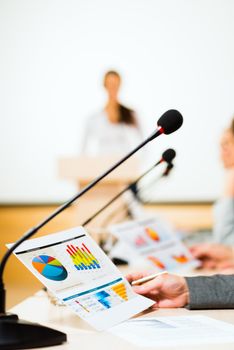 close-up microphone, on the background of business communication at the conference